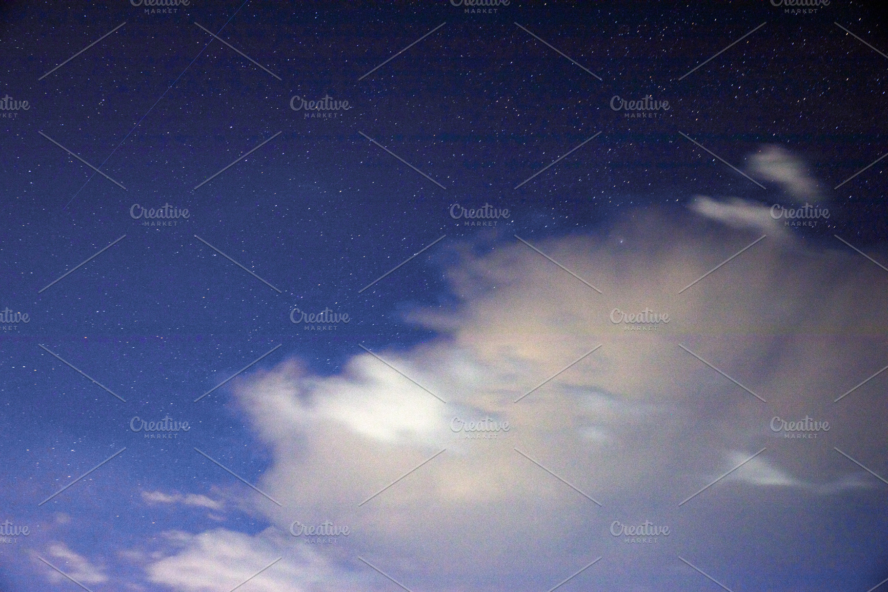 Starry night sky with scattered clouds illuminated by moonlight, offering a ser, an Animal Photo by Ales Munt