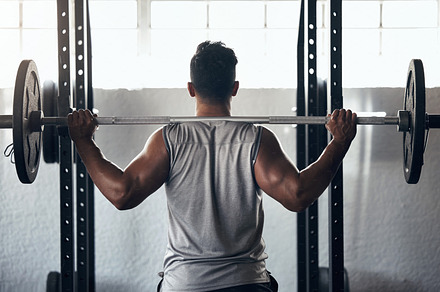 Fitness exercise in gym, man weightlifting barbell motivation and athlete training body with heavy equipment. Strong back muscles, professional workout routine squat and focus on healthy lifestyle, a Photo by Peopleimages.com