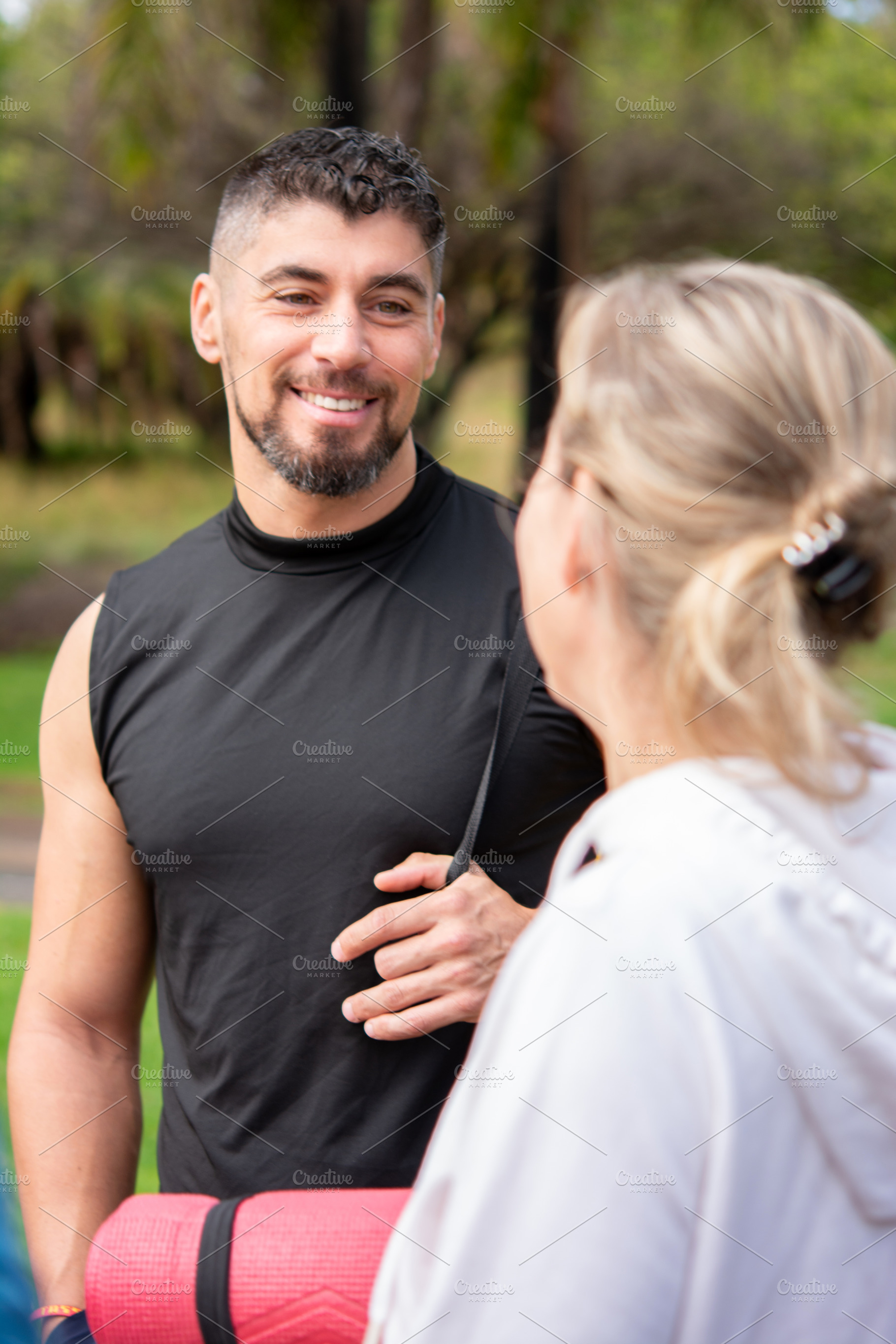 Smiling Man and Woman Talking Before Outdoor Workout Session, a Person Photo by etorres69