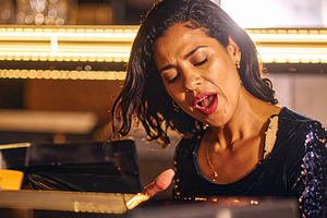 A beautiful singer playing piano at bar, a Person Photo by DanFLCreativo