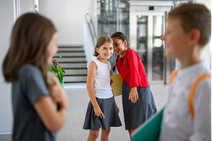 Schoolgirls teasing or gossiping, a School & Education Photo by HalfPoint