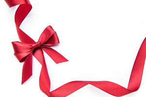 Red ribbon bow forming gift border on white, a Holiday Photo by Olena Rudo