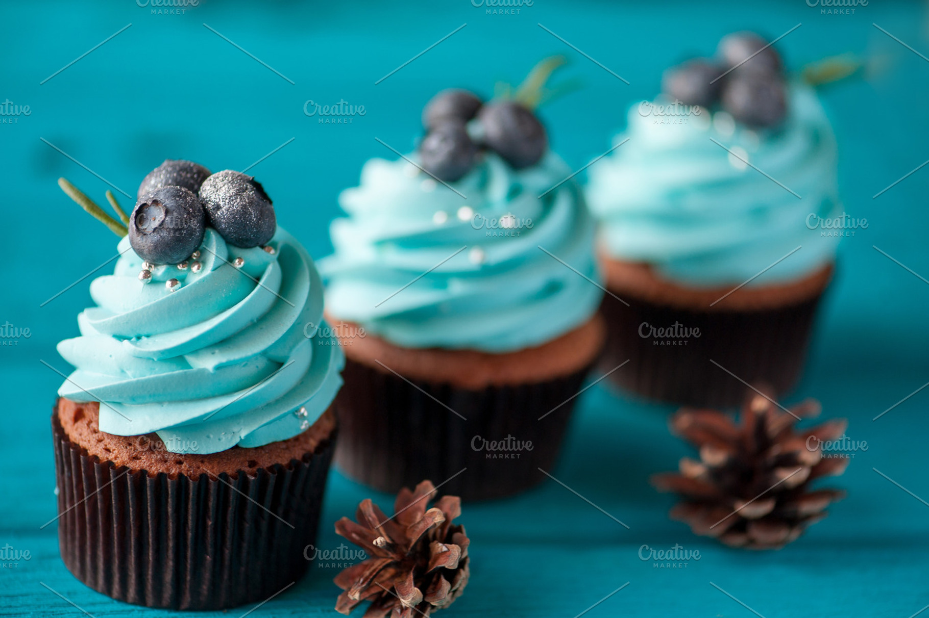 Three cupcake with blueberry cream featuring dessert, sweet, and stand, a Food & Drink Photo by MarinaMassel