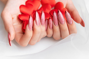 Woman holding red hearts with elegant manicure nails, a Beauty & Fashion Photo by Olena Rudo