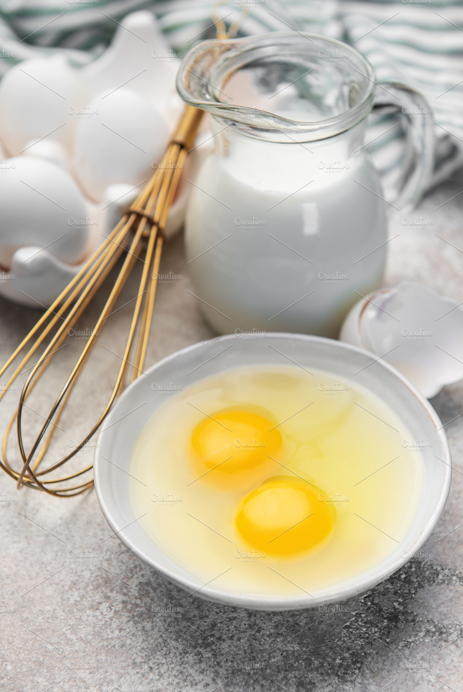 Fresh eggs, milk, and a whisk ready for cooking, a Food & Drink Photo by Olena Rudo