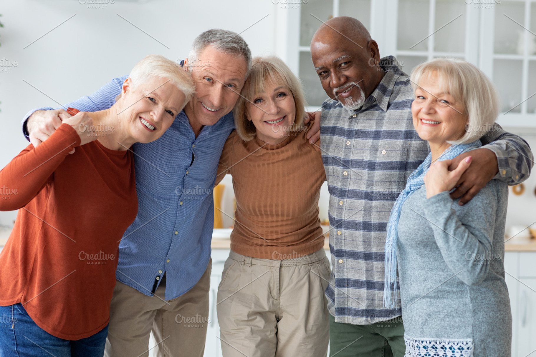Group photo of happy elderly people hugging, smiling at camera, a Photo by Prostock-Studio