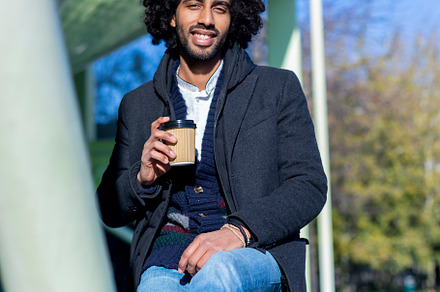 Handsome modern african american man with beard smiling positive standing at th, a Person Photo by RF Images