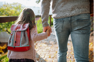 Parent walking child to school on, a School & Education Photo by HalfPoint