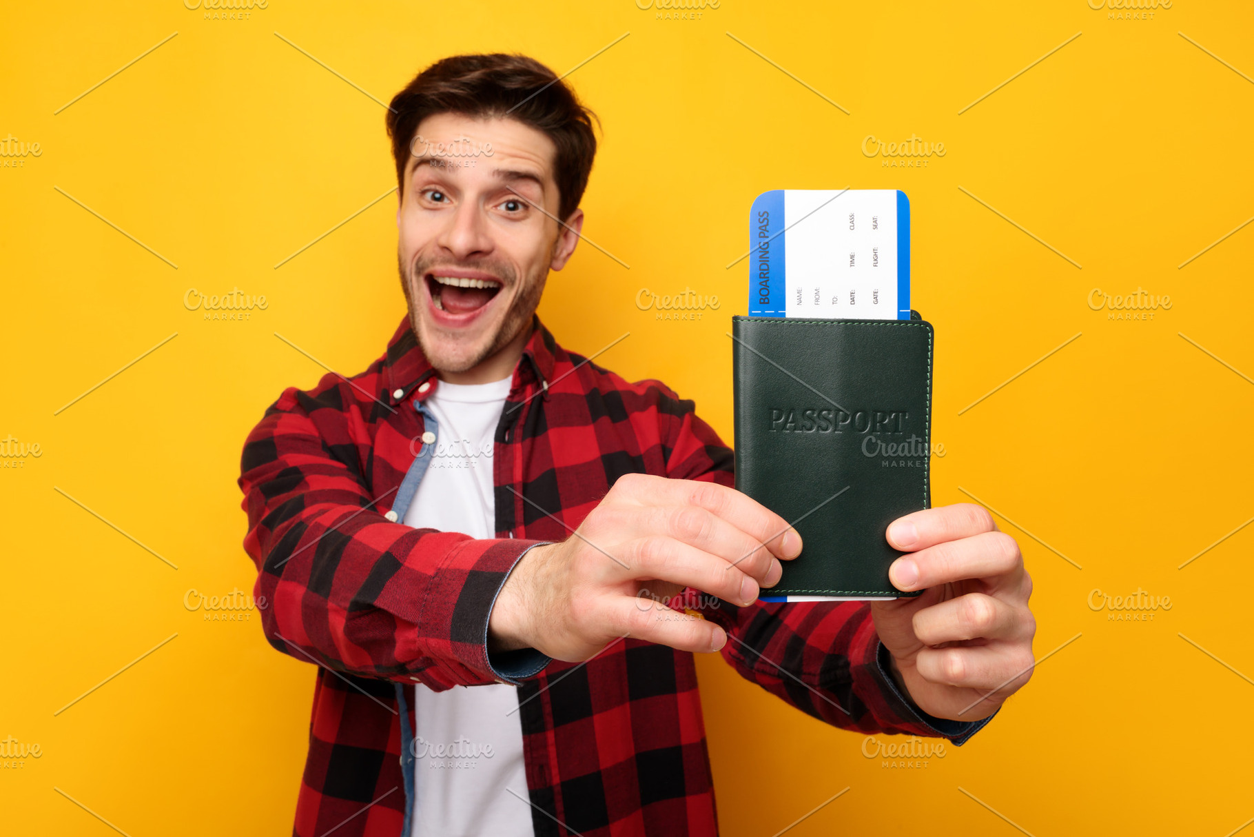Excited young man holding showing tickets and passport, a Photo by Prostock-Studio