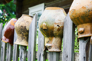 Old broken clay jugs on wooden fence, a Food & Drink Photo by BOOCYS