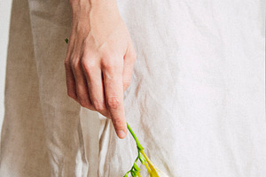 A girl with a flower containing summer, linen, and breeze