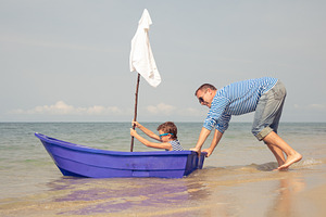 Father and son  playing on the beach containing cruise, fun, and father