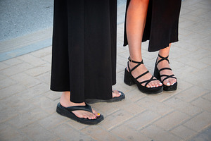 Person's feet in sandals, a Person Photo by DanFLCreativo