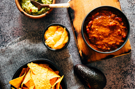 Mexican nachos with guacamole, cheddar cheese and chili.