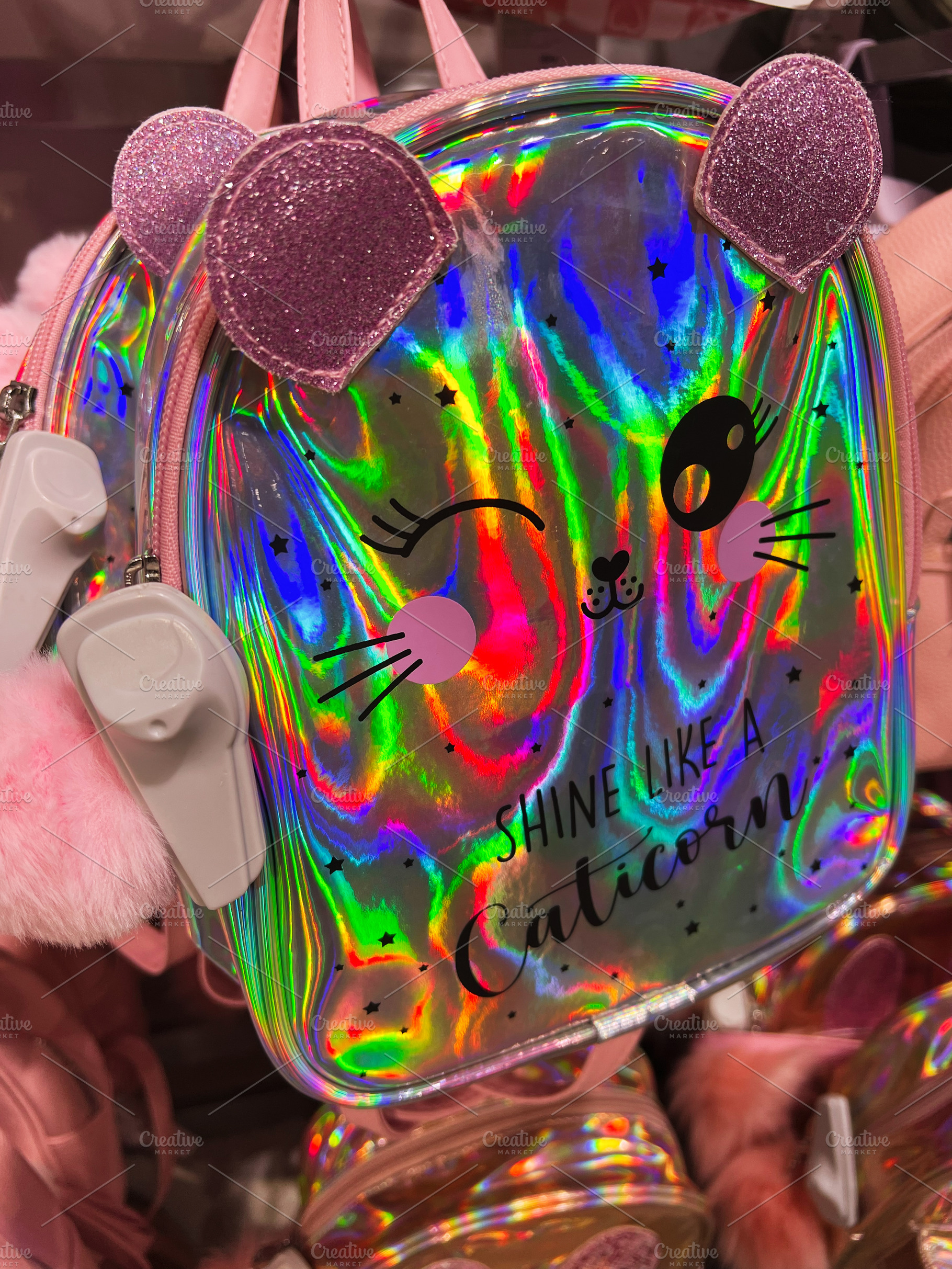 Holographic bag with cute pink ears and text design in vibrant hues, a Photo by AS photostudio
