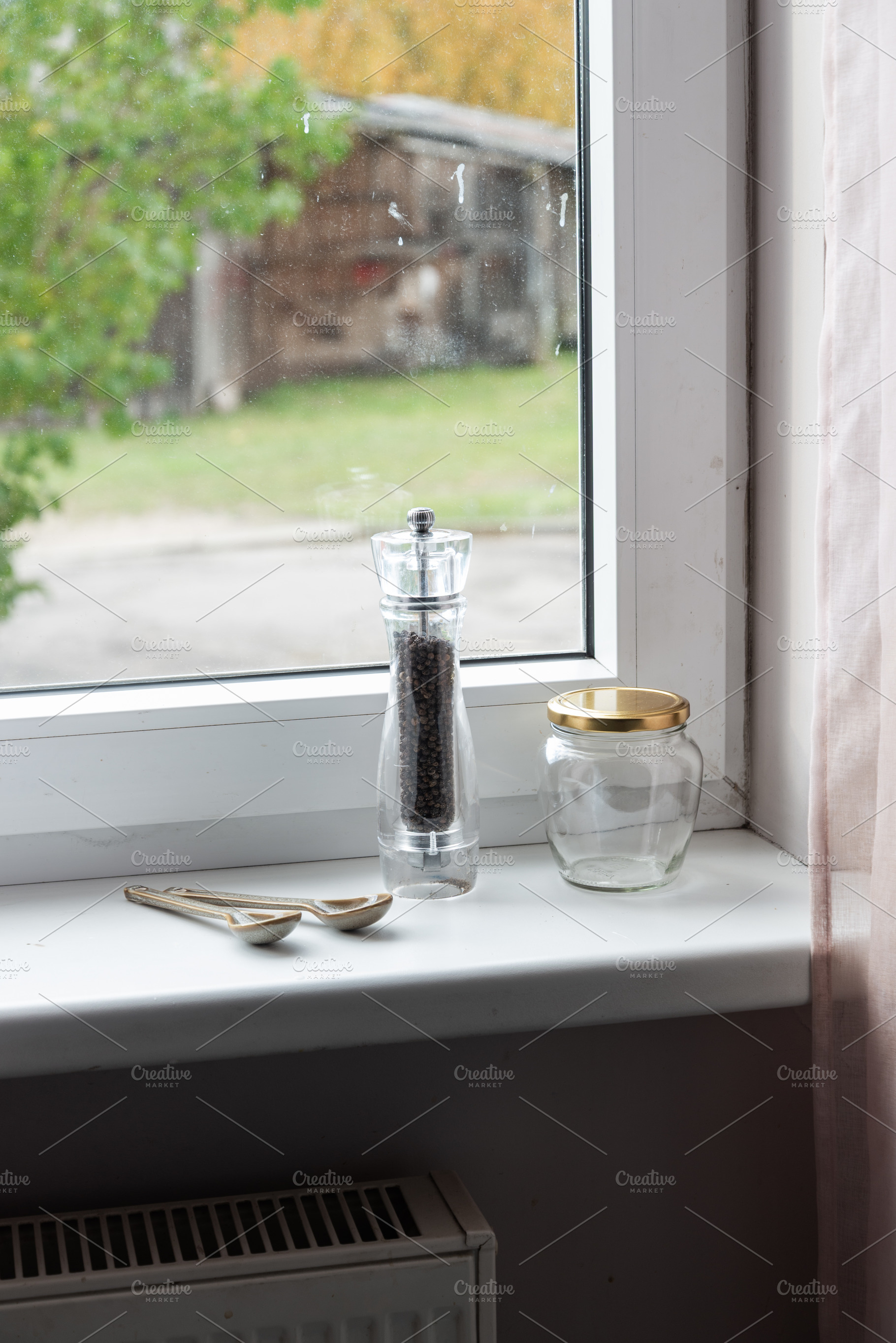 Empty spice jars and pepper mill on a windowsill, an Industrial Photo by MDBildes