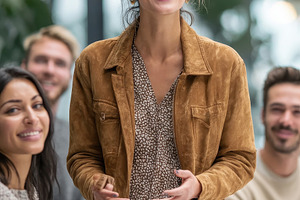 Happy woman presenting at a business, a Photo by Pixeness Studio