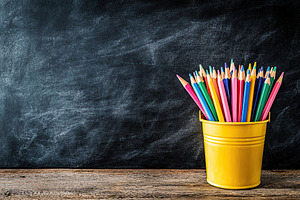 Wooden colorful rainbow pencils in bucket on wooden table, a School & Education Photo by AlyaAnd