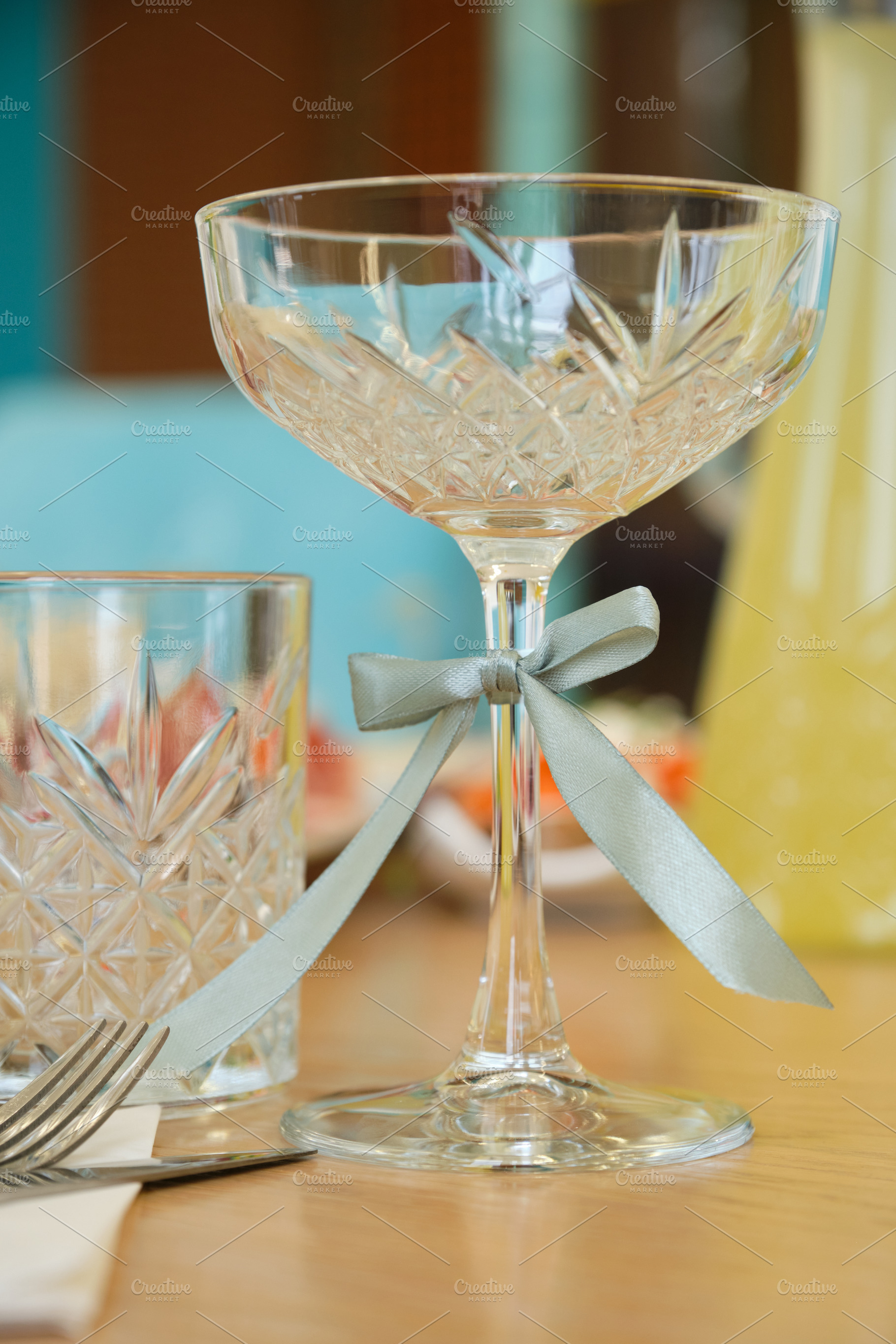 Close-up of elegant crystal champagne coupe with decorative satin ribbon., a Food & Drink Photo by Rohan Photography