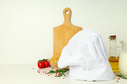 Concept of cooking food with chef hat, space for text, a Food & Drink Photo by AtlasStudio PRO