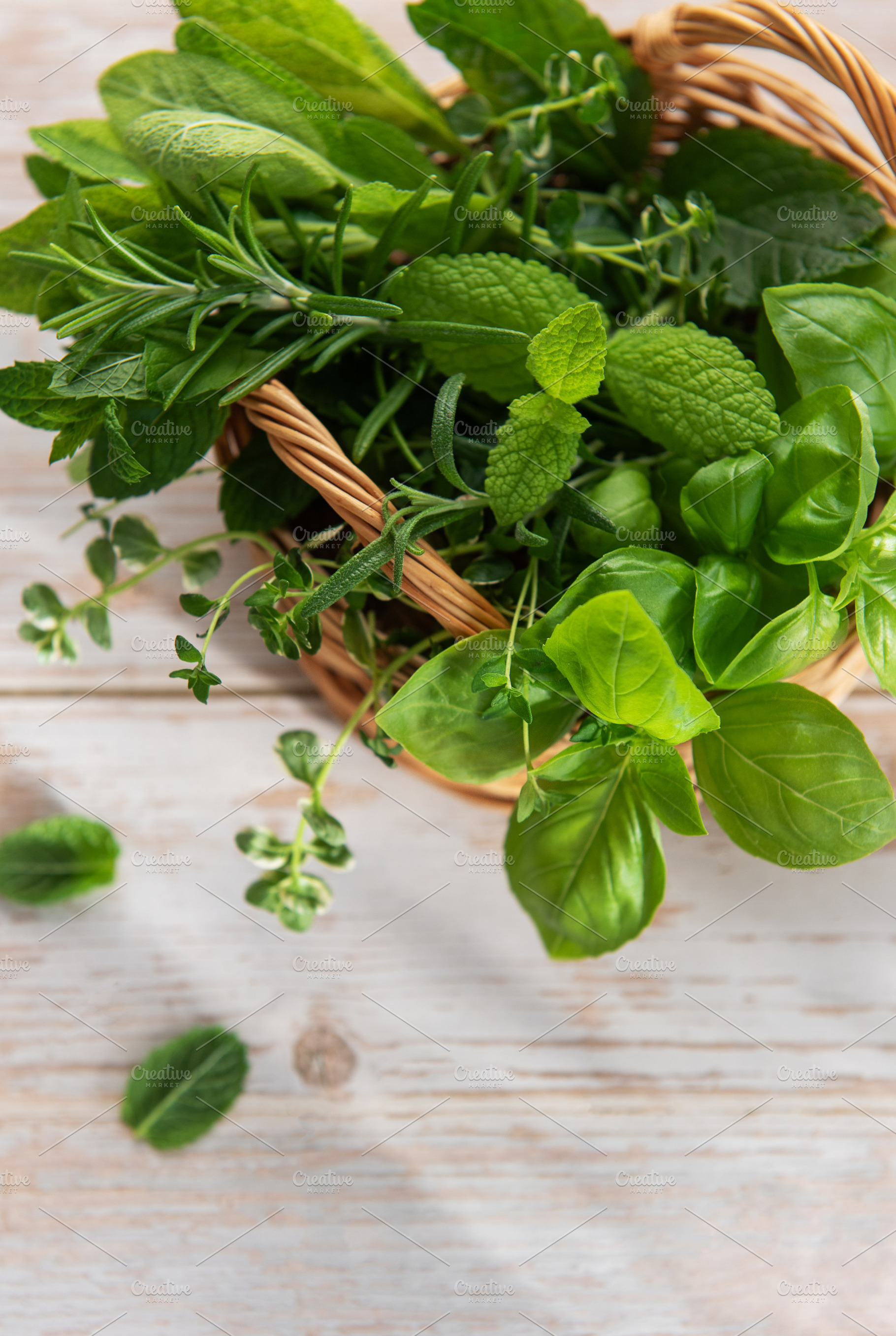 Fresh garden herbs in weaving basket for cooking, a Food & Drink Photo by Olena Rudo