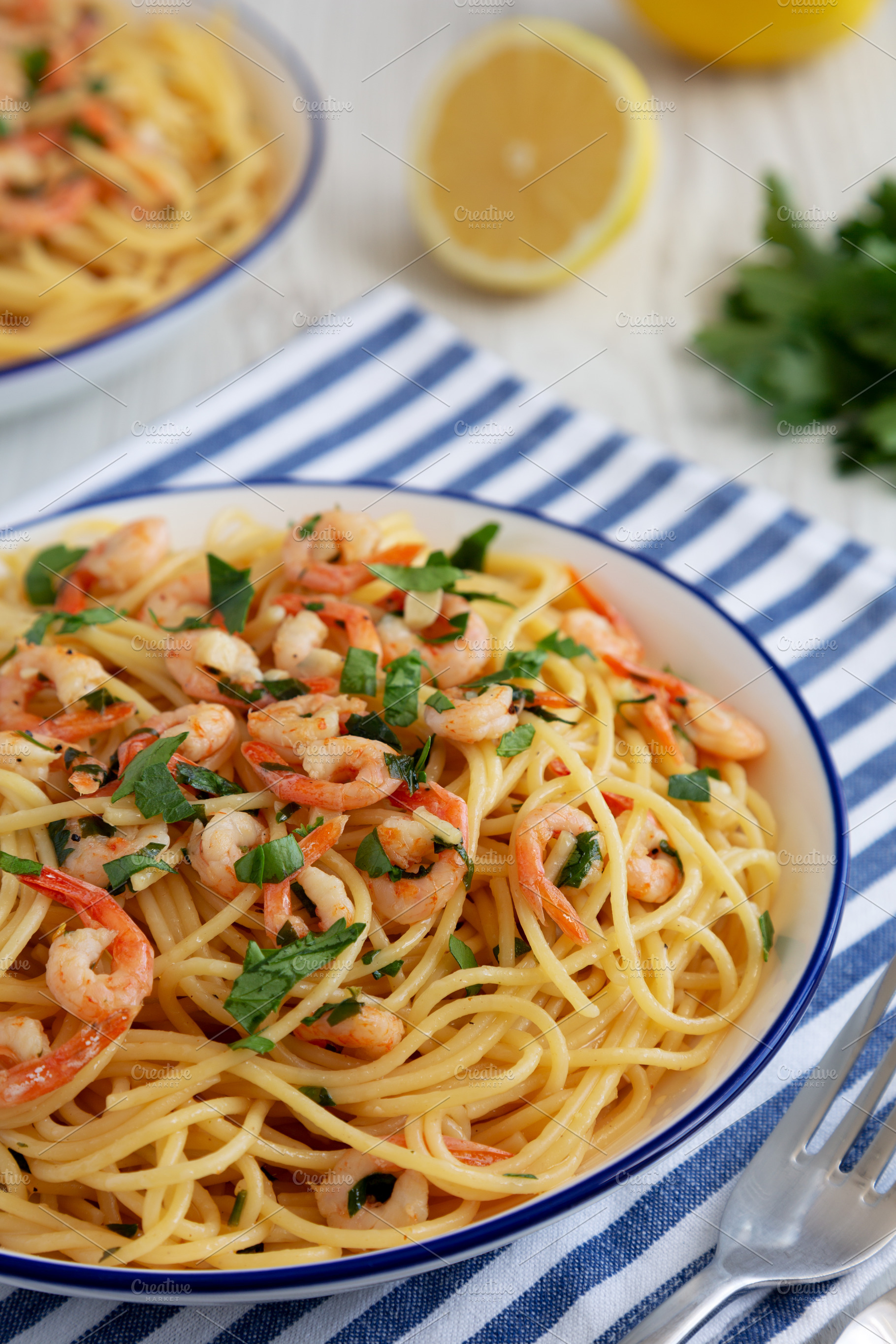 Homemade Garlic Shrimp Scampi with Parsley on a Plate, low angle, a Food & Drink Photo by LiudmylaChuhunova