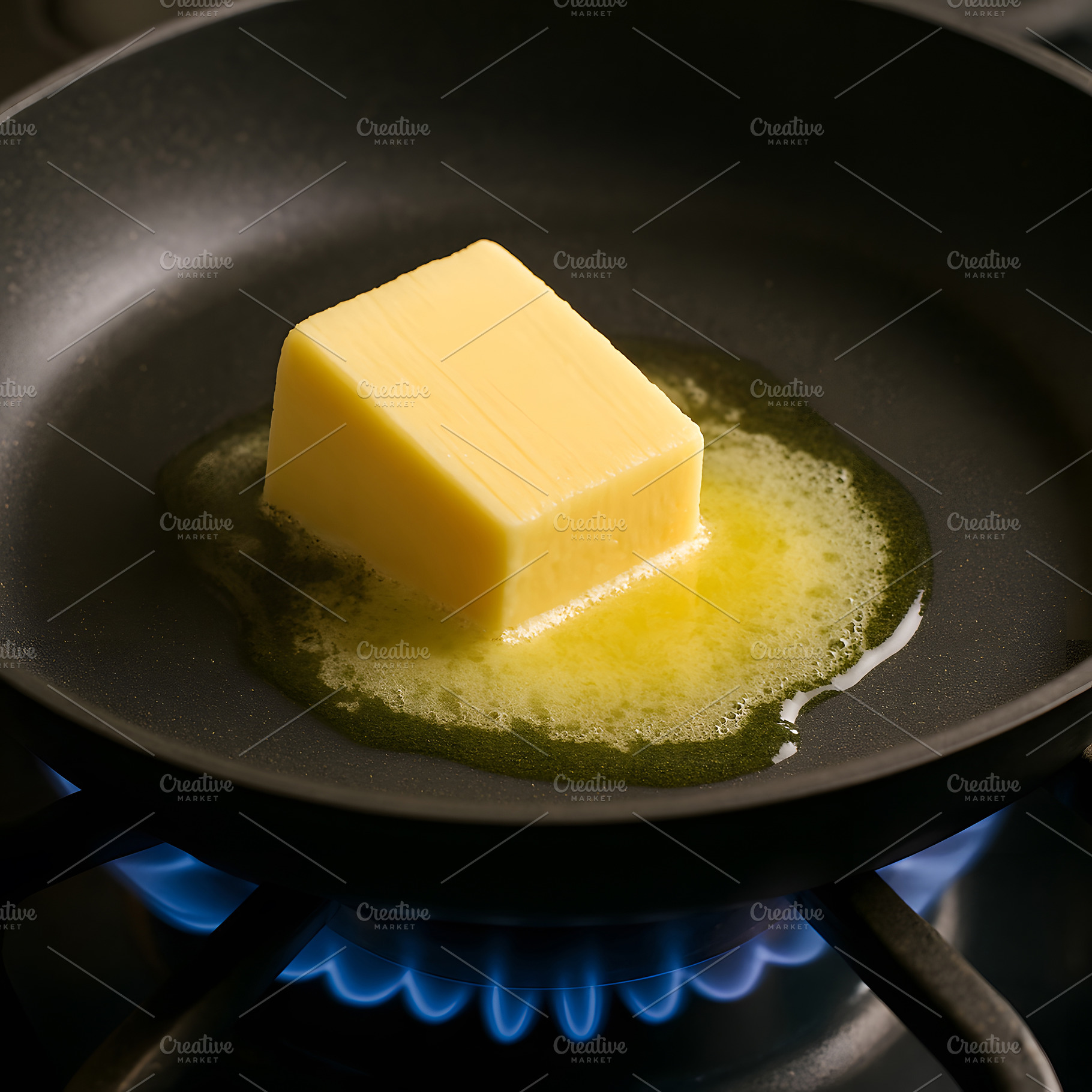 Butter cube melting in frying pan with blue flame below, a Food & Drink Photo by GoodGoods
