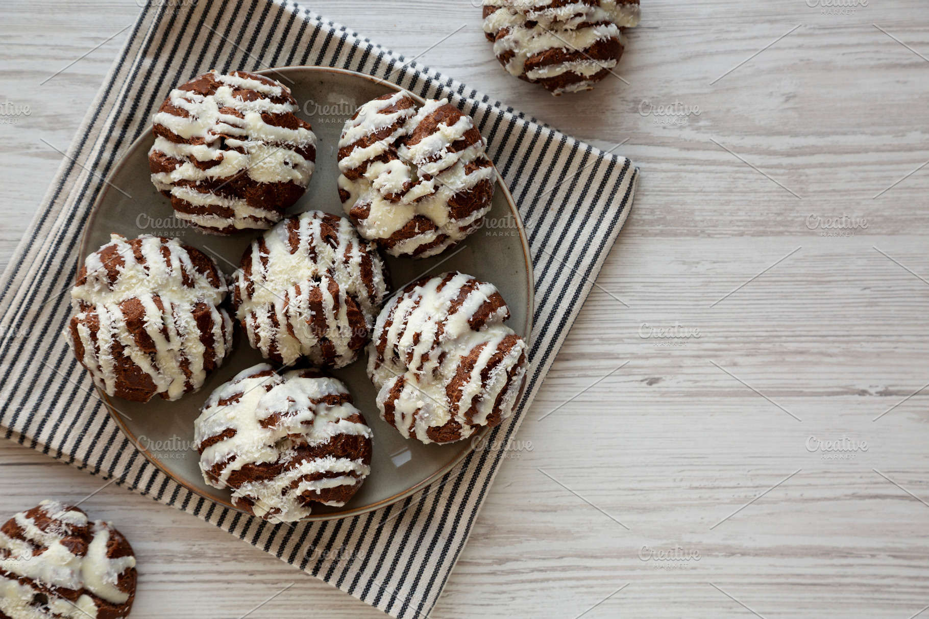 Homemade Profiteroles with Coconut Cream on a Plate, top view. C, a Food & Drink Photo by LiudmylaChuhunova
