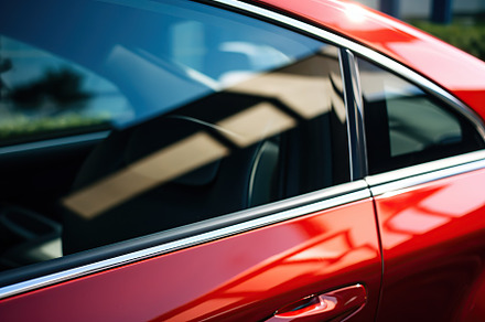 Closeup photo of a new red modern car, a Transportation Photo by AlyaAnd