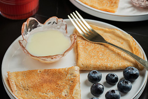 Pancakes with blueberry and honey on a white plate, a Food & Drink Photo by Budarinphoto