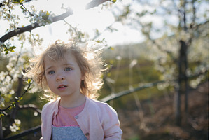 Small toddler girl standing outdoors, a Person Photo by HalfPoint