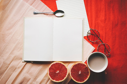 Colorful flat lay of an open diary surrounded by common objetcs, an Abstract Photo by NanihtaCreative