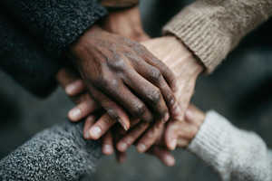 Diverse hands clasped together unity, a Photo by Pixeness Studio