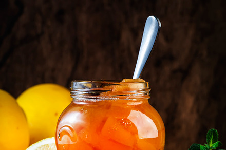 Autumn Quince jam or confiture in glass jar with cinnamon, lemon, a Food & Drink Photo by 5PH