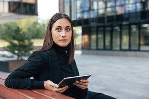 Young brunette with digital tablet, a Business Photo by Artem Varnitsin