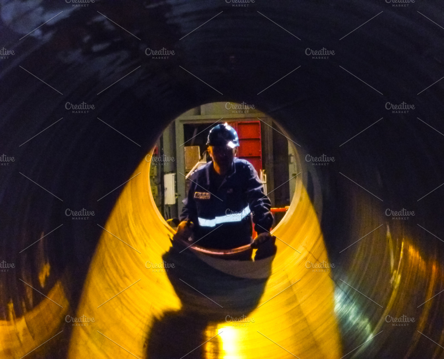 Worker looking into the pipeline. Construction of the pipeline, a Person Photo by ELEONIMAGES