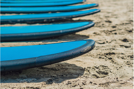 Blue surfboards in the sand on the, a Nature Photo by Elizaveta Galitskaya