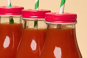 Glass bottles with tomato juice with red caps., a Food & Drink Photo by ndanko