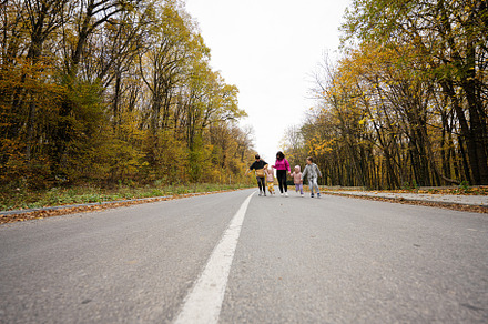 Mother with four kids running on road at autumn fall forest., a Person Photo by AS photostudio