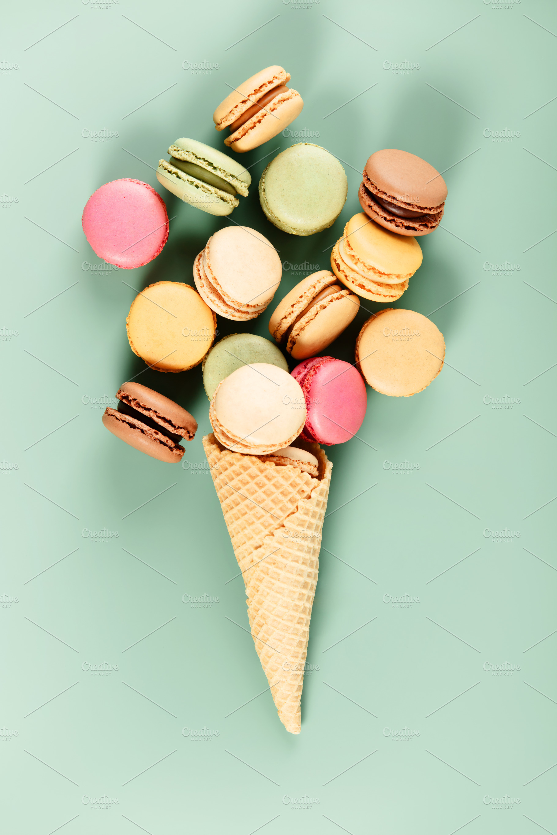 Colorful Macarons in Ice Cream Cone on Pastel Background, a Holiday Photo by Natalia Klenova's Shop