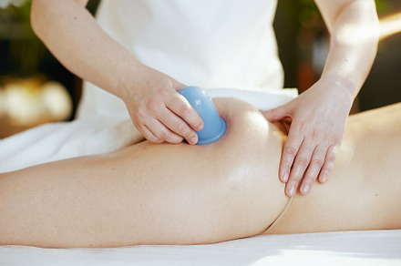 Closeup on medical massage therapist massaging clients buttocks, a Photo by Alliance Images