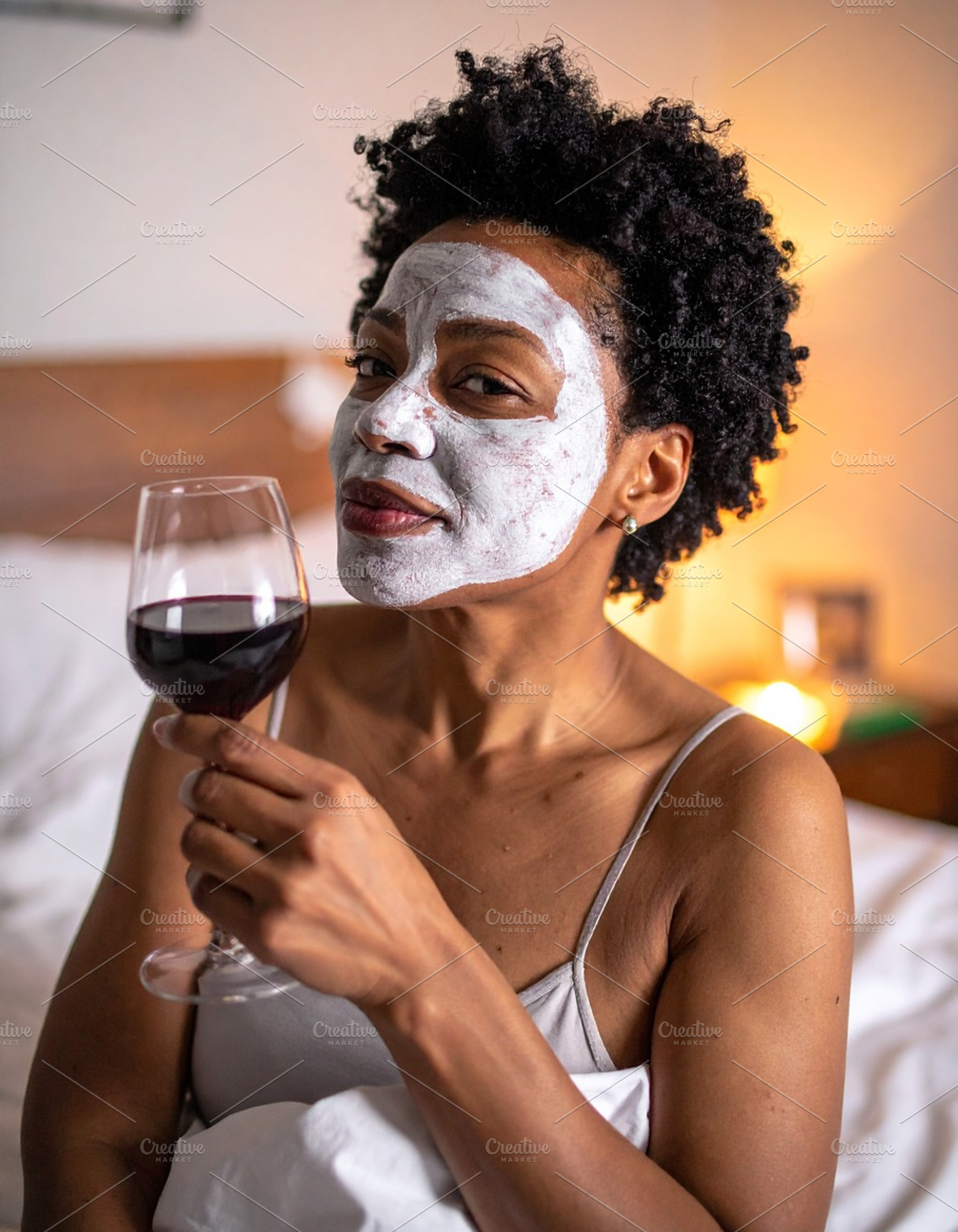 Woman with her face covered by a white facial mask while holding, a Health & Medical Photo by DanFLCreativo