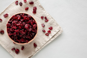 Organic Dried Cranberries in a Bowl, top view. Space for text., a Food & Drink Photo by LiudmylaChuhunova