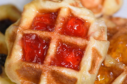 Close up fresh waffles with above strawberry jam