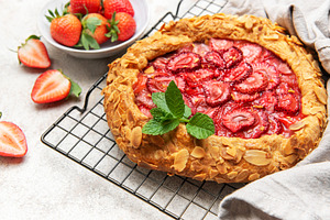 Delicious homemade strawberry galette cooling on wire rack, a Food & Drink Photo by Olena Rudo