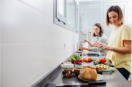 Two women preparing healthy food on, a Food & Drink Photo by Manu Reyes