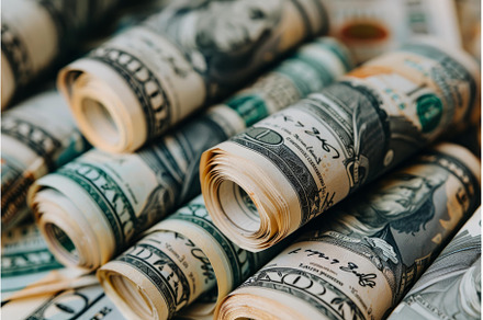 Close up of rolled up american one, a Business Photo by Ylivdesign