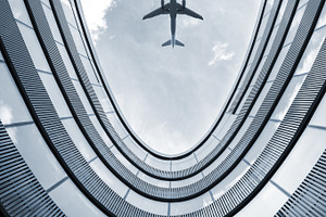 Modern building with flying airplane, a Transportation Photo by BOOCYS