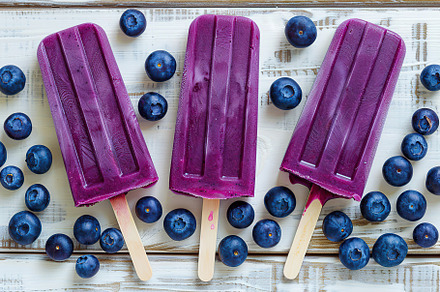 Ice cream popsicles with organic blueberries on wooden background, a Food & Drink Photo by AlyaAnd