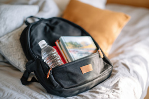 Colorful backpack and school supplies on a bed, an Arts & Entertainment Photo by AlyaAnd